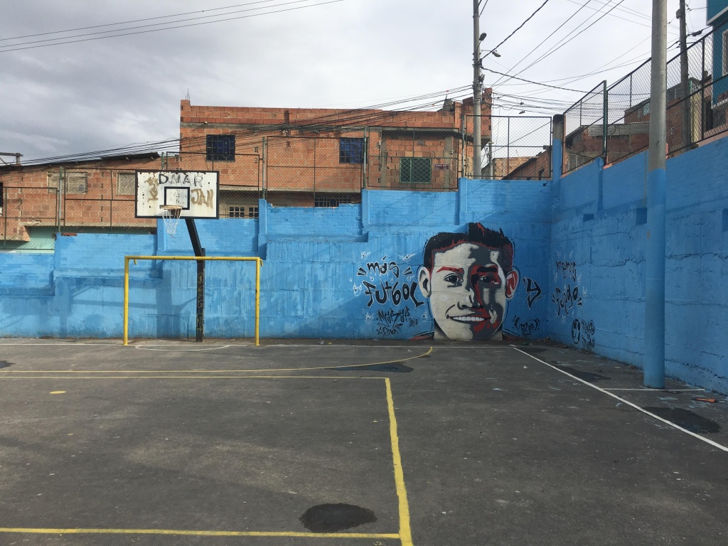 A James Rodriguez mural on a Colombian football pitch.